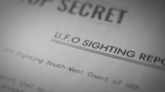 Extreme close up on government top secret report about UFO observation sighting. Military or navy classified confidential file document regarding reports on unexplained phenomenons and alien activity