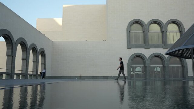 Man Walking Toward MIA Archways, Cinematic Doha Skyline Reveal and Islamic Architecture Qatar