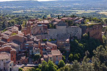 Fototapeta premium Roussillon village on ochre plateau, traditional Provencal houses and terraced streets visible from above