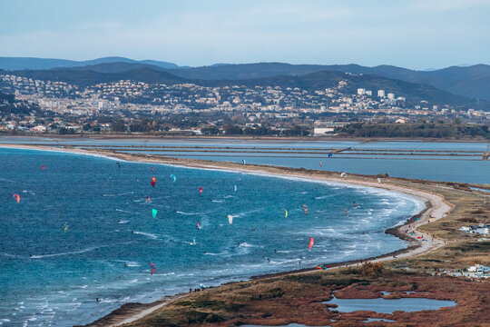 Panoramic view over the Giens peninsula and its double tombolo with sandy coastline, lagoon and kite surfers seen from viewpoint