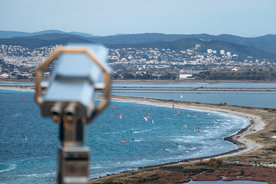 Panoramic view over the Giens peninsula and its double tombolo with sandy coastline, lagoon and kite surfers seen from viewpoint