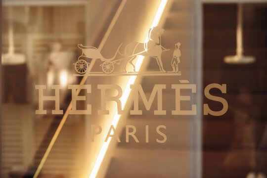 Saint-Tropez, France - December 8, 2025: Hermes Paris logo on a luxury store window with reflections and interior lighting in Saint-Tropez