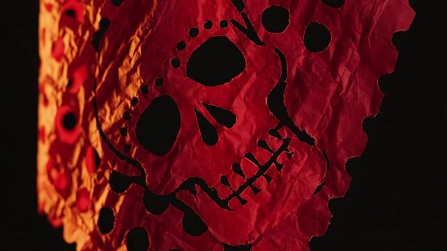 traditional papel picado skull, festive day of the dead decoration, intricate paper cutting, vibrant red cutout, cultural celebration