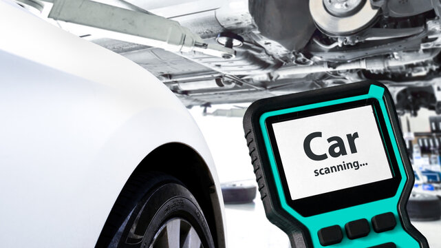 Car Diagnostic Tool in Workshop, A digital scanner performs a system check on a vehicle lifted in a garage, focusing on advanced diagnostics and engine troubleshooting.