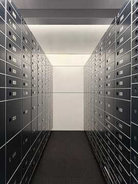 Two rows of partly decommissioned safe deposit boxes in a room