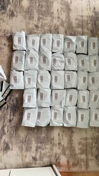 Moscow, Russia, 03.05.2026 Seller organizes retail parcel for marketplace shipping. Small business owner prepares inventory for domestic logistics distribution. E-commerce packaging process.
