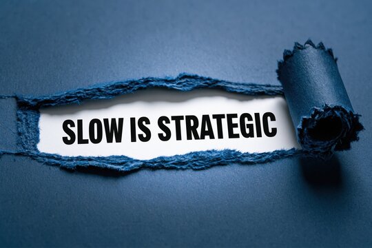 Slow Is Strategic a business philosophy appearing under torn blue paper