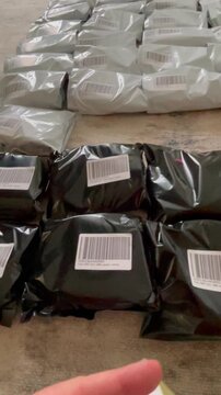 Moscow, Russia, 03.05.2026 Woman seller labeling plastic parcel bags for online marketplace delivery. Small business owner preparing shipment of goods for customer orders in home warehouse.