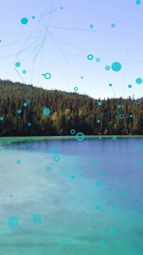 Vertical video: Teal overlay rising, drifting down and growing over lake and trees, showing links