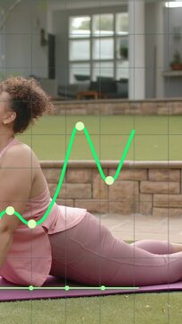 Vertical video: Woman shifting arms onto purple mat arching back while green graph tracking health
