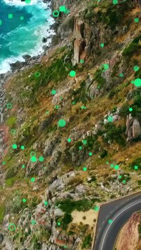 Vertical video: Drone rising while green markers floating, grouping over shore rocks to show pillar