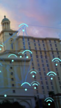 Vertical video: Neon-blue arcs appearing, cream tower hosting pulsing network mapping rooftop links