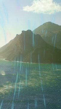Vertical video: Sun shifting causing cyan streaks crossing rock island, waves glinting to add mood