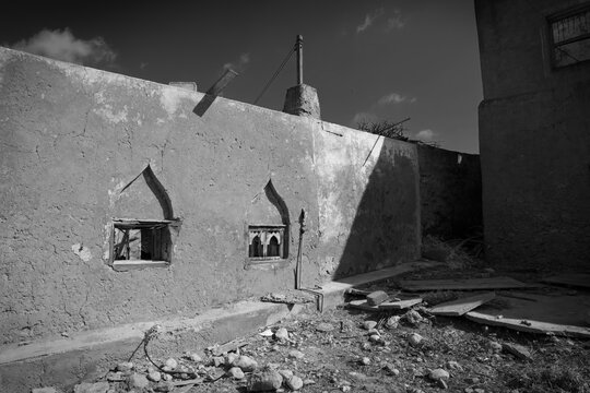 Ancient Dhofar Architecture with Ornate Windows and Dusty Ground