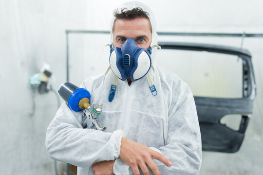 spray painter looking at the camera
