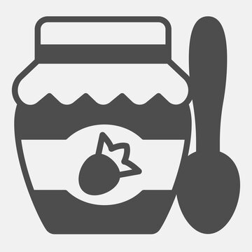 Jar of strawberry jam solid icon, sweet food concept. Vector graphics. Jam jar with tablespoon sign with glyph style for mobile or web design.