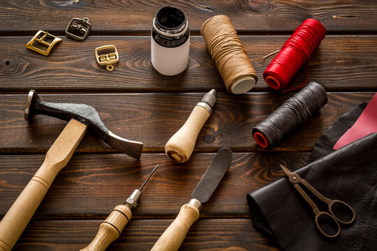 Tools for repair shoes. Hammer, awl, knife, thread on table, top view