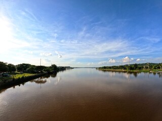 Obraz premium Wide angle view of the Mahakam River under a blue sky, East Kalimantan, Indonesia.