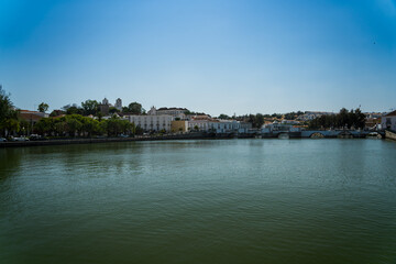 Obraz premium Faro's Historic Waterfront Reflection Under a Bright Blue Sky