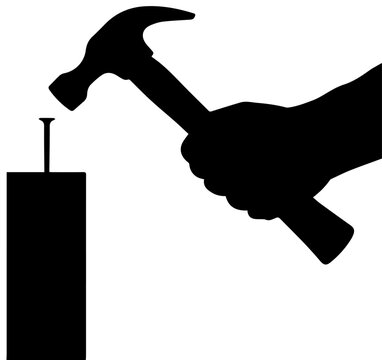 Black Silhouette of a Hand Using a Hammer to Drive a Nail into Wood Tool and Construction Concept