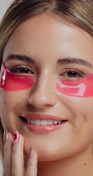 Eye patch, smile and face of woman for fine line treatment, hyaluronic acid or beauty. Dark circles cosmetics, collagen mask and self care with person for dermatology, hydration and skincare glow