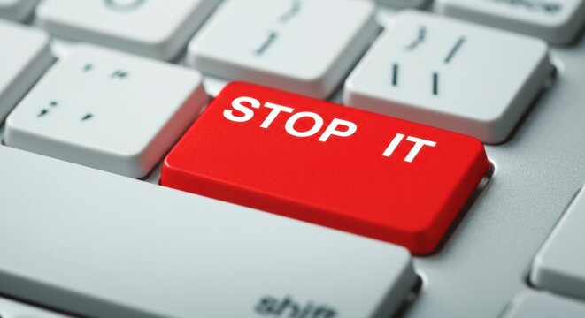 Red keyboard key labeled STOP IT placed among white keys as a symbolic alert