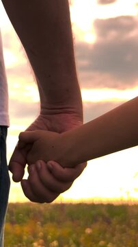 happy family, father holding child hand sunset, toddler child parent holding hand nature, Safe with dad, Father-and-daughter relationship, Father-and-son bond, Childhood security, Loving embrace