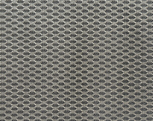 Close up of knitted wear fabric in grey color. Knitted sweater fabric forming net or lattice shape. Seamless background texture. © TMR Studio