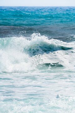 Waves on the beach in windy day. Blue sea and the blue sky.