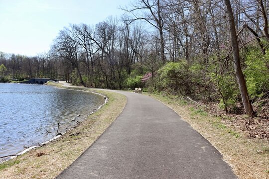 The empty walkway near the lake in the park.