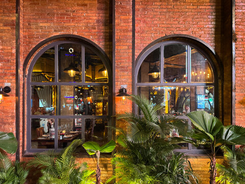 architectural design of arches and pillars with red brickwall cladding finishes. Commonly found in old building, warehouse, or a fine dining restaurant.