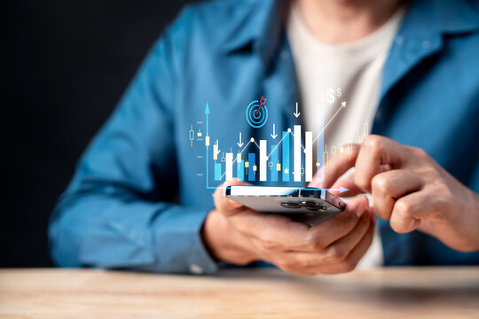 Dollar cost averaging investment strategy and financial planning. Man using smartphone with digital stock market chart to analyze data.