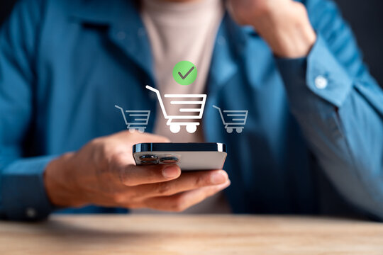 Online shopping comparison and product selection concept. Man using smartphone with shopping cart icons to buy items.