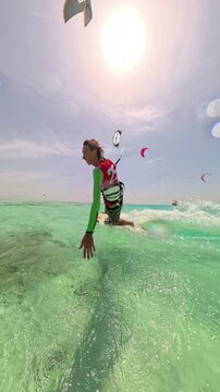 skilled kitesurfer jumping changing stance landing smoothly riding fast on turquoise sea under clear summer sky enjoying freedom adrenaline extreme sport lifestyle adventure travel energy outdoors