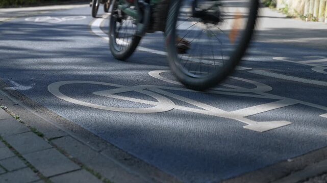 Close Up of a Bicycle Road. Blue Bike Lane With the Bicycles passing on the white symbol of a bike in Konstanz, Germany.