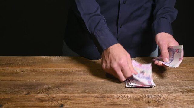 man counts 200 banknotes. Ukrainian currency is on table. businessman hands count cash. income, savings and finance of Ukraine. Money is in men hands. concept abundance, cash flow and profit.
