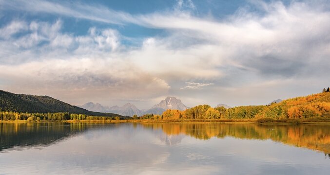 Mount Moran reflected in Snake River, morning mood at Oxbow Bend, autumn trees and Grand Teton Range, Grand Teton National Park, Wyoming, USA