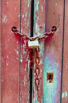 Lock on a chain, wood door