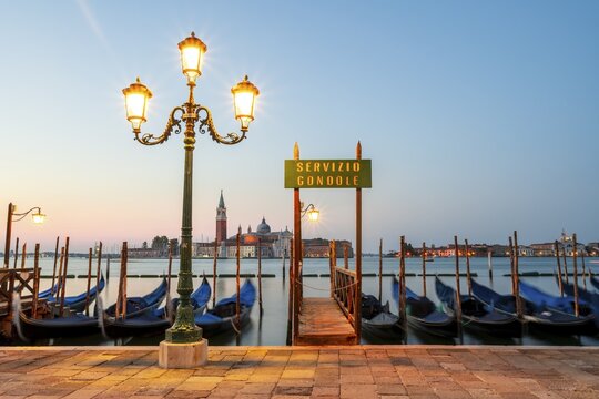 Boat landing stage, Servicio Gondole, jetty with Venetian gondolas, in the back church San Giorgio Maggiore, long exposure, dawn, Venice, Veneto, Italy