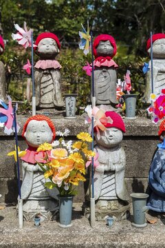 Jizo statues with red caps, protective deities for deceased children, Zōjōji Temple, Buddhist temple complex, Tokyo, Japan