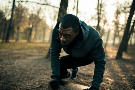 Determined runner warming up in forest park