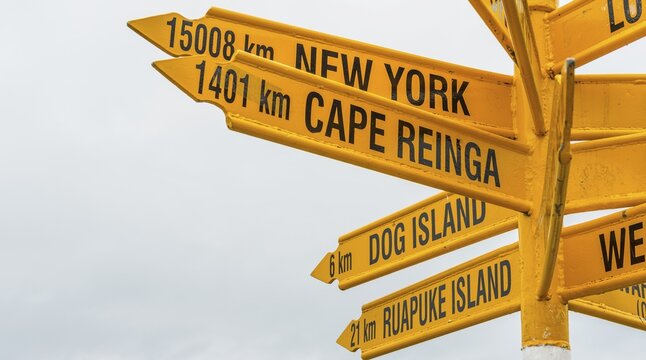 Yellow signs, signpost with different destinations, cities and distances, Bluff, South Island, New Zealand
