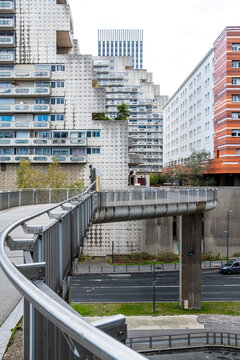 Bridge walkway crosses modern corporate architecture in Paris business district at La Defense connecting urban district business zones with strong perspective