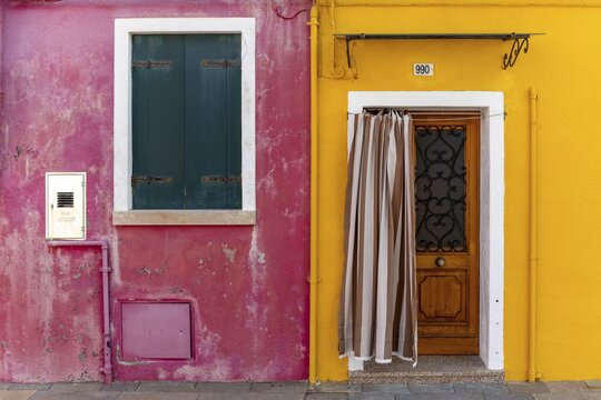 Door and window of a yellow and pink house, colorful houses, colorful facade, Burano Island, Venice, Veneto, Italy