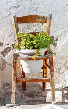 Wooden chair with flower box, Lefkes, Paros, Cyclades, Greece