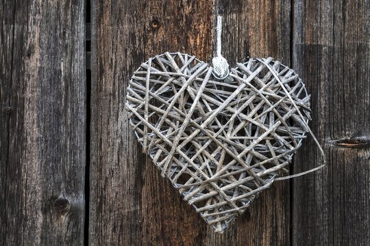 Woven heart hanging on an old wooden facade made of weathered wood, near Oberstdorf, Oberallg&auml;u, Allg&auml;u, Bavaria, Germany