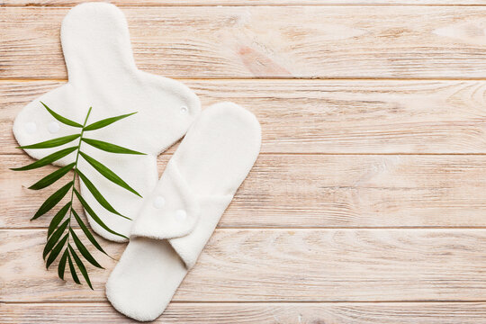 lean feminine sanitary napkin with green leaf. Absence of menstruation in woman. Minimal concept of female menopause. Copy space top view