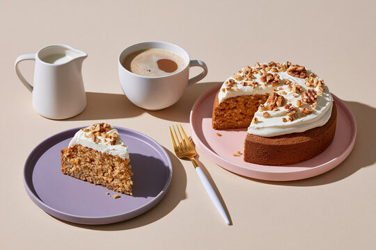 Still life of cake, coffee and milk pitcher on cream surface with elegant pastel tableware arrangement.