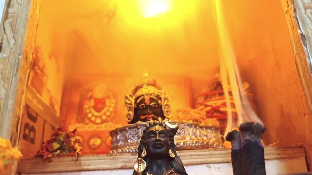 Lord Mahakal Shiva Statue in Hindu Temple with Holy Incense Smoke and Warm Cinematic Lighting