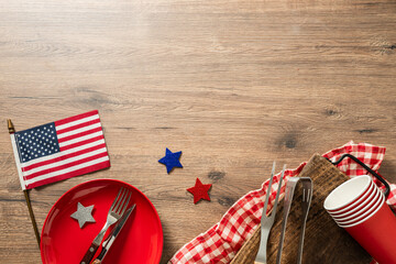 Independence day table setting with American flag plate and copy space top view